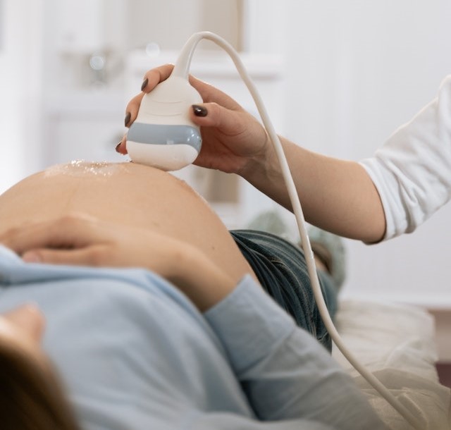 Pregnant woman receiving ultrasound exam