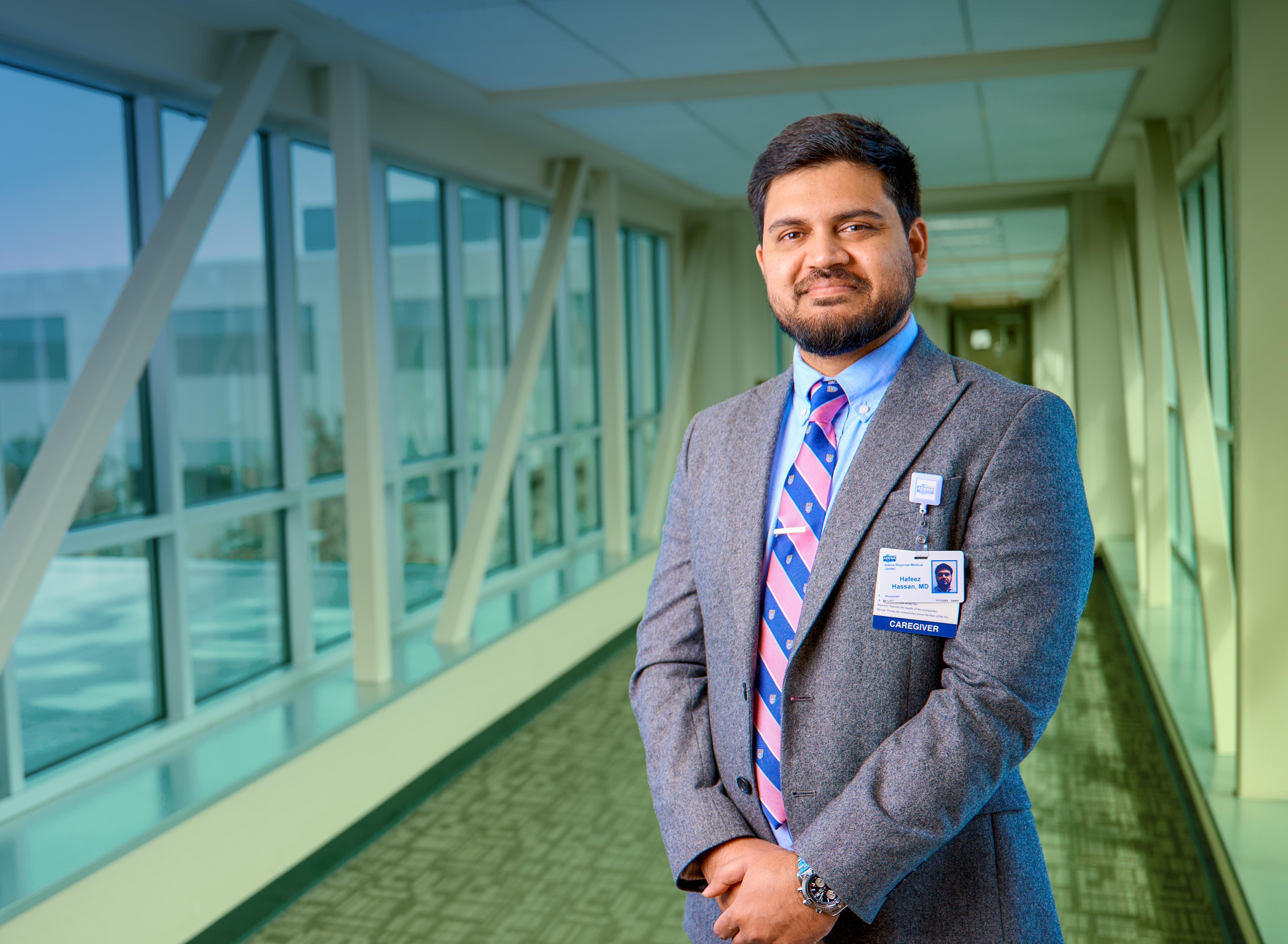 Interventional cardiologist Hafeez Hassan, MD posing in front of windows on the Adena campus.