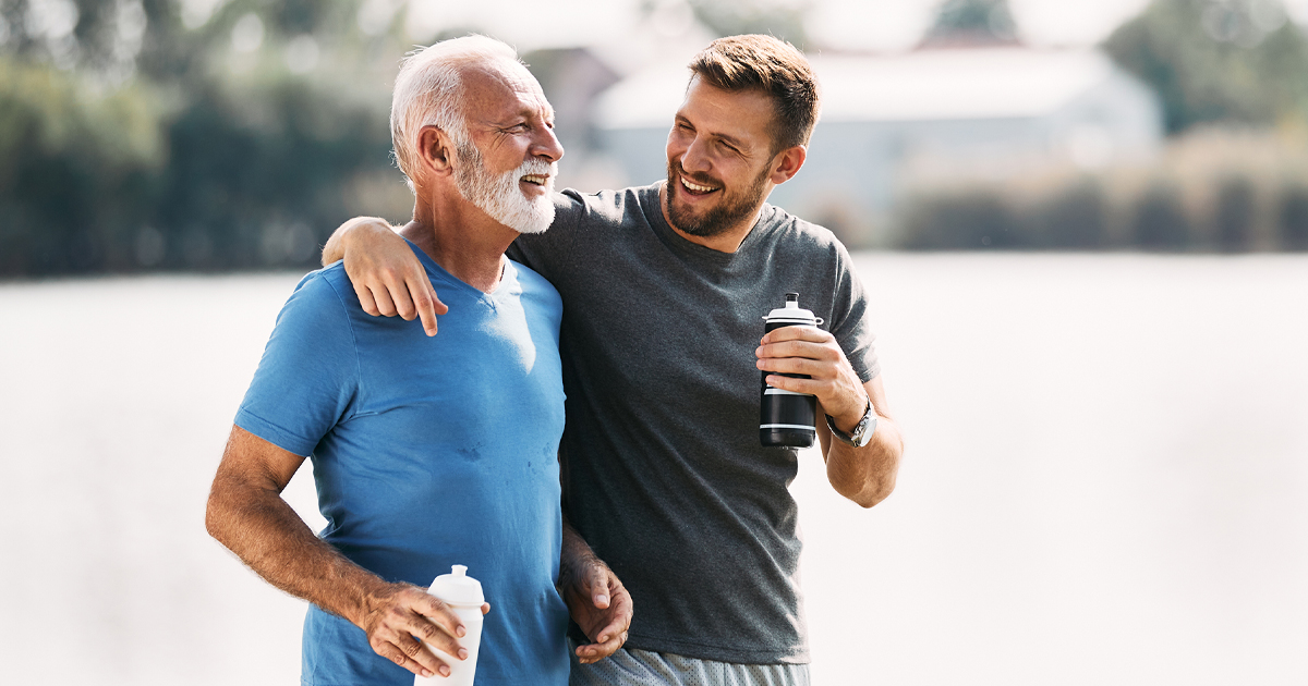 2 Healthy men, who just finished up a work out together, embracing.