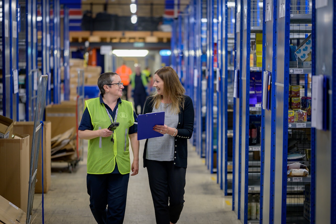 Employees walking and talking in warehouse