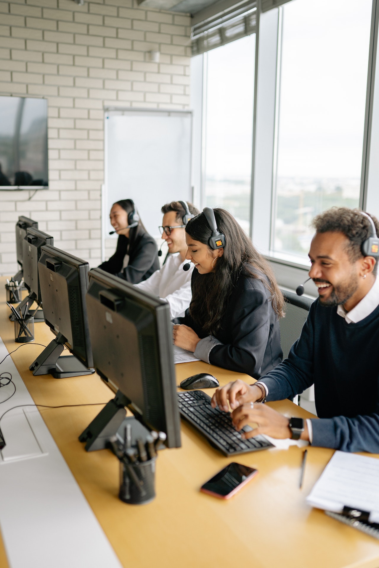 Office employees making and answering phone calls at desk