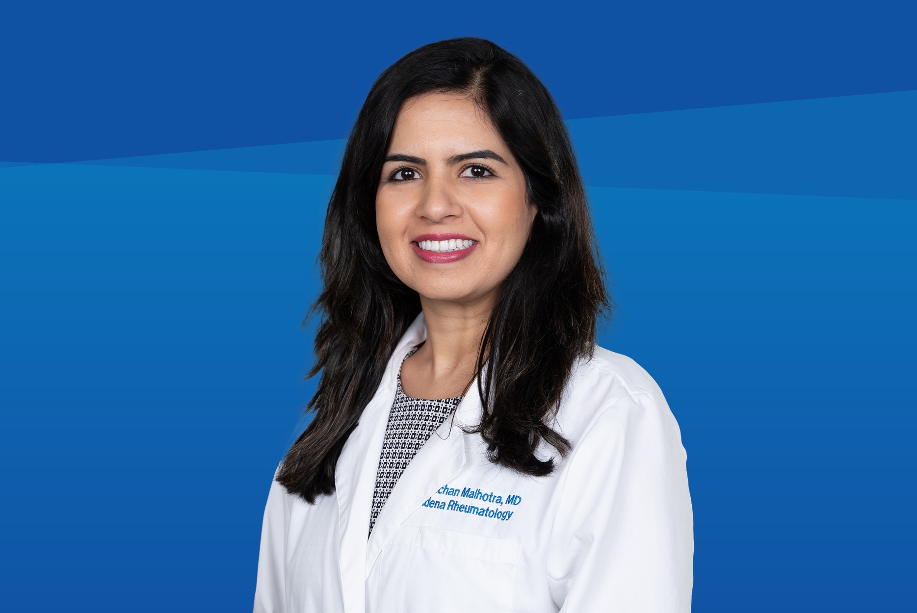 Dr. Malhorta posing for a banner for a doctors day blog.