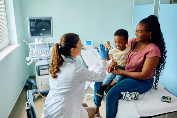 Stock photo of a mom and her son visiting with a pediatrician.