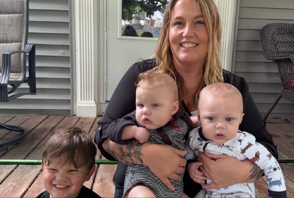 Courtney Williams and her kids sitting on a porch.