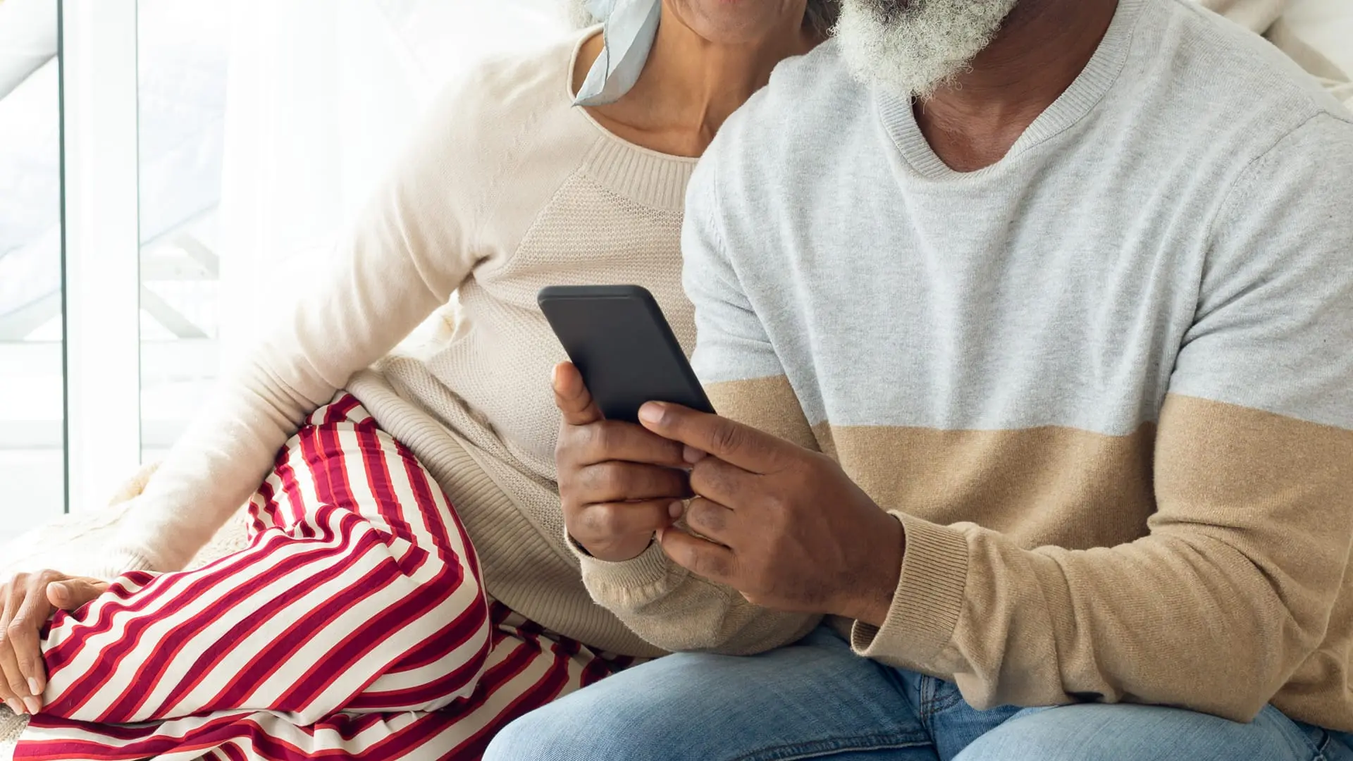 Older couple using their phones to access the patient portal.